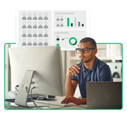 表やグラフを背景に、パソコンの画面を見つめる人