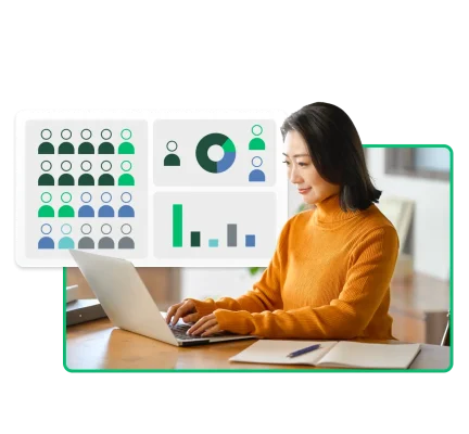 A woman on a laptop reviews some graphs