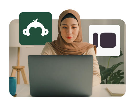 A woman working on her laptop with the SurveyMonkey and Typeform logos floating in the foreground.