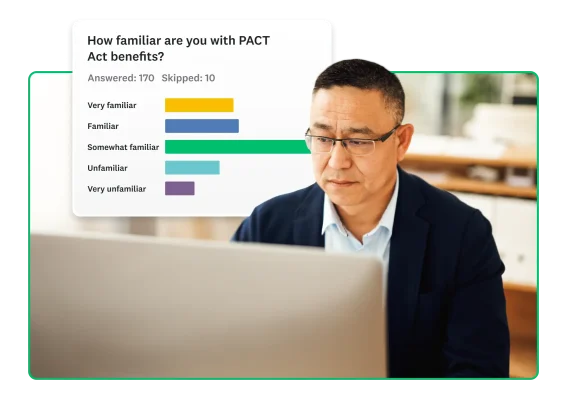 A man looks at laptop, with survey results in background