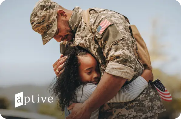 Veteran hugging a young girl with Aptive logo
