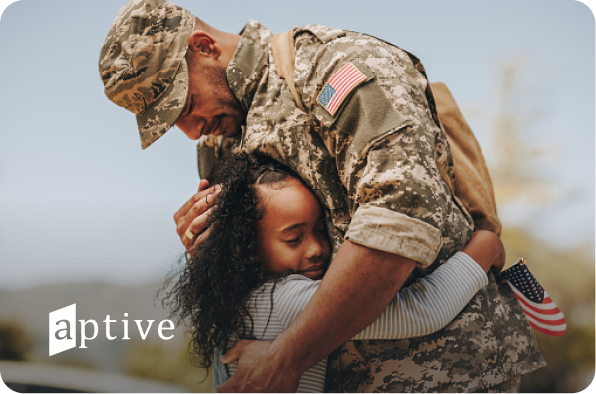 veteran hugging a young girl with aptive logo