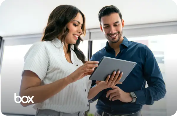 Woman and a man looking at a tablet with Box logo