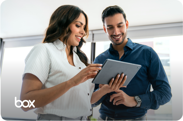 woman and a man looking at a tablet with box logo