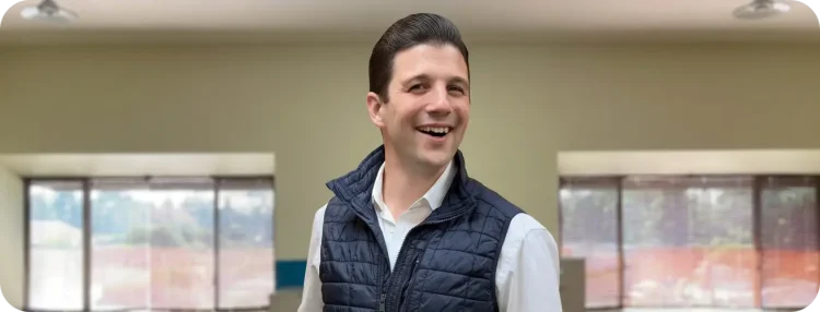 Smiling man wearing a puffer vest
