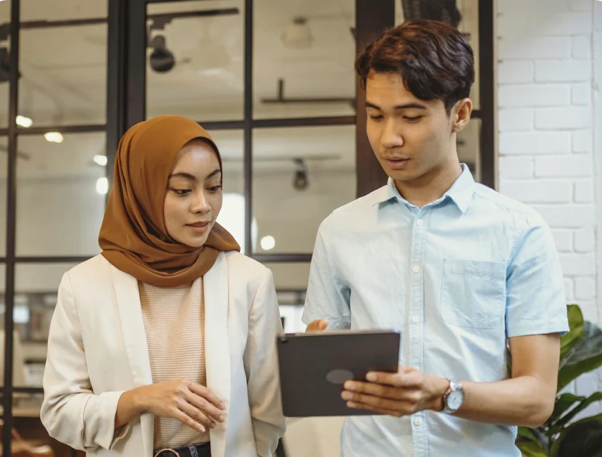 Two people looking at a tablet