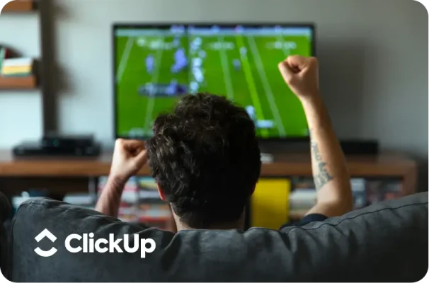 Man watching sports game on television with ClickUp logo at bottom