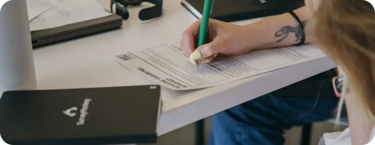 Hands filling out employment forms