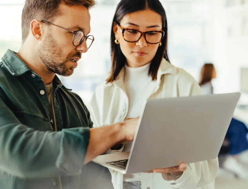 Two people looking at a laptop