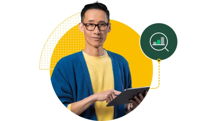 Man holding tablet next to bar graph