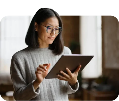 Woman typing on tablet