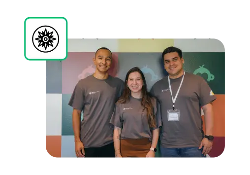 Three smiling SurveyMonkey employees standing next to each other