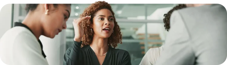 Employees sitting in a room talking