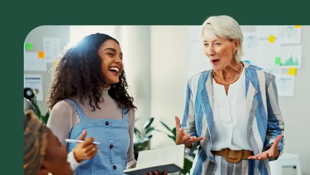 Two smiling woman working together