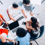 Diverse group of employees working around a table