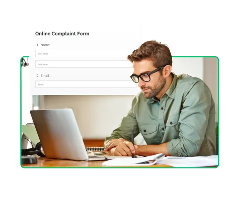 man with glasses looking at laptop