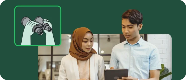 Two employees looking at a tablet, next to an illustration of binoculars