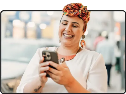 Smiling woman looking at phone screen