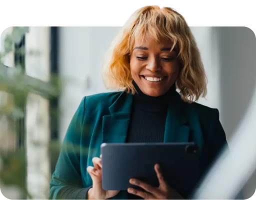 Smiling woman typing on tablet