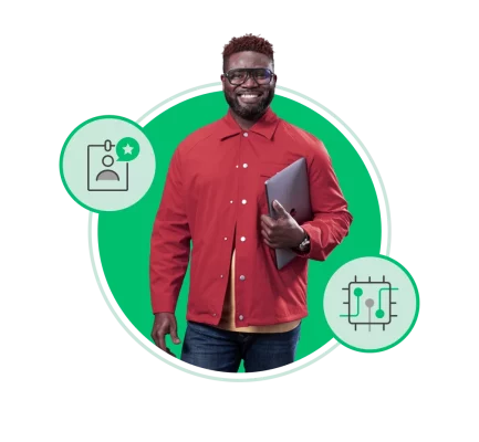 Smiling man holding closed laptop under arm