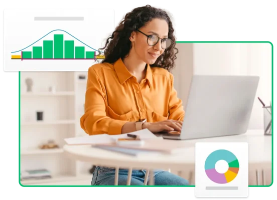 Donna che digita sul portatile, accanto a grafici e diagrammi