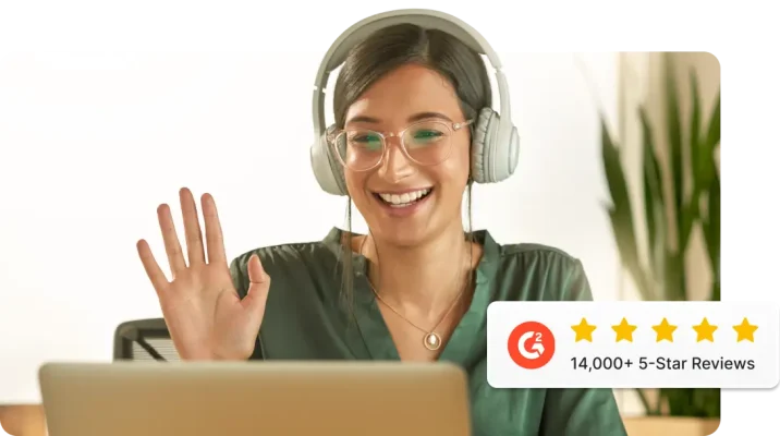 A smiling woman wearing headphones waving at a laptop screen, next to the G2 logo and five stars, with text saying 14,000 five-star reviews