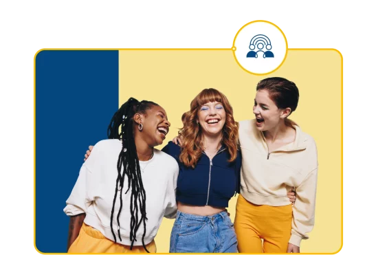 Three young women laughing and hugging each other