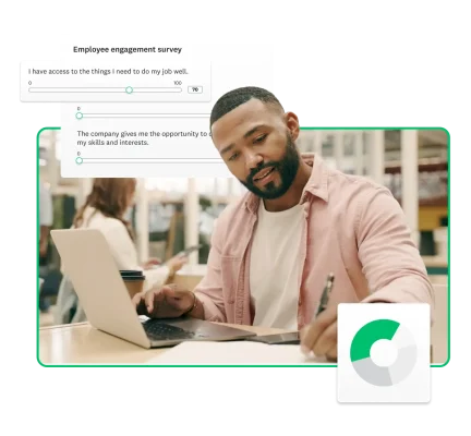 An employee engagement survey next to a man working on a laptop