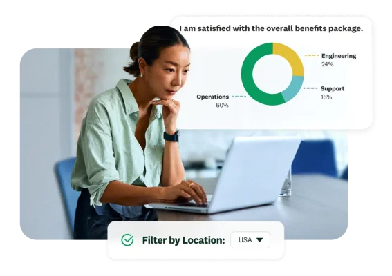 Professional working on a laptop with a SurveyMonkey employee sentiment breakdown chart overlay