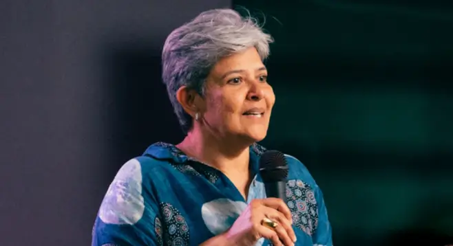Meera Vaidyanathan, Chief Product Officer of SurveyMonkey, speaking into a microphone