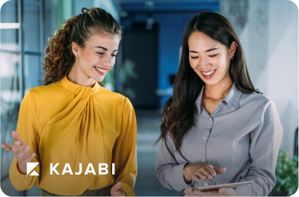 two women looking at a tablet with kajabi logo