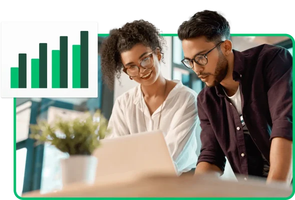 Two people looking at a laptop screen together next to a bar graph