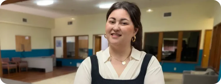 Smiling woman standing in front of a conference desk
