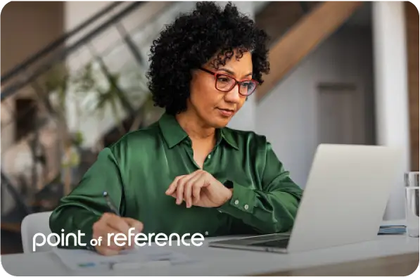 Woman looking at her laptop with Point of Reference logo