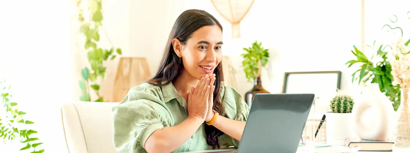 Person looking relieved while working on laptop