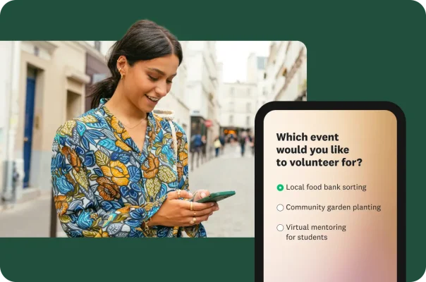A person walking down the street and looking at a mobile survey for volunteer sign-ups.