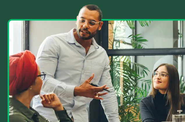 Three people having a discussion in a meeting room