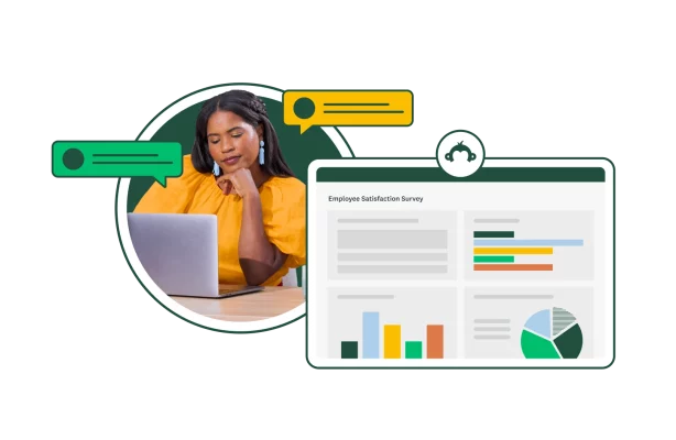 woman sitting looking at laptop and charts