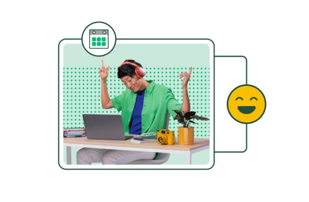 man wearing headphones gestures jokingly at a laptop