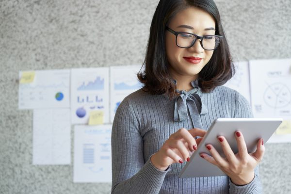 Woman using modern gadgets in work