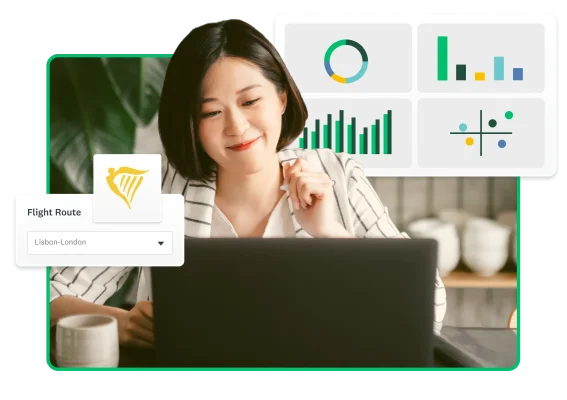 A woman typing on a laptop surrounded by charts and graphs