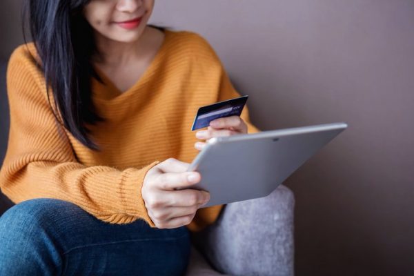 Woman leaving an online review about her new credit card