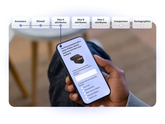 Someone reading a survey question on their phone, answering questions about a series of ideas