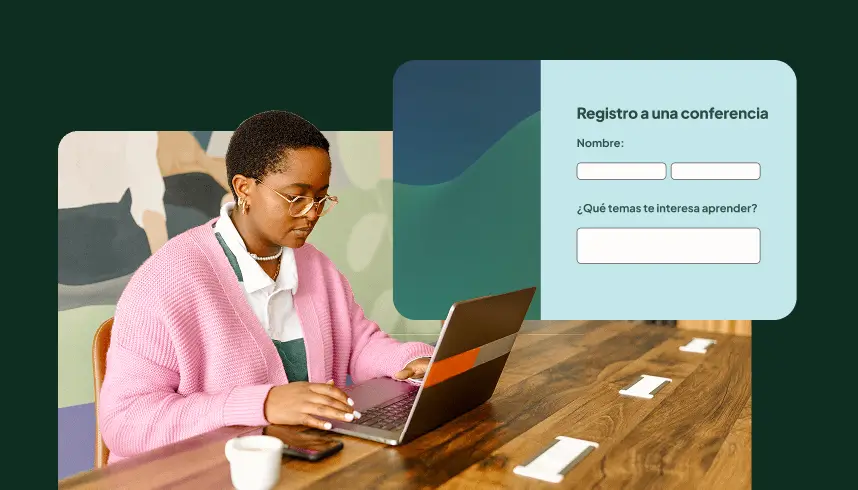 Una persona en un escritorio llena un formulario de inscripción a una conferencia en una computadora portátil