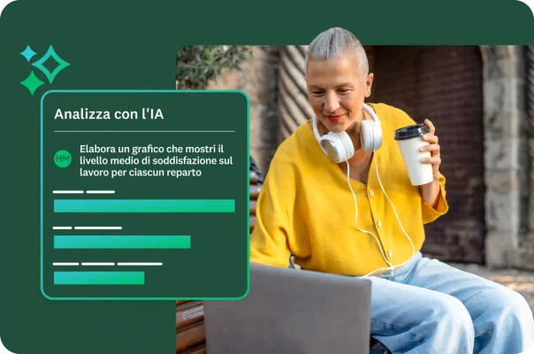 Donna con capelli bianchi corti che indossa le cuffie e un cardigan giallo mentre guarda il suo laptop seduta su una panca. Un riquadro sovrapposto all'immagine in cui si legge "Analizza con l'IA" e il prompt che chiede di mostrare la soddisfazione sul lavoro media per ogni reparto, seguito da un grafico a barre.