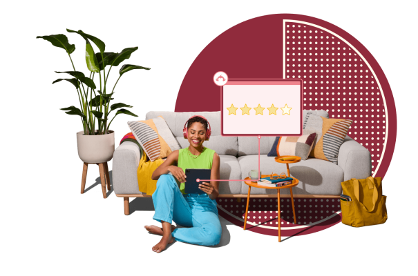 Woman wearing headphones on tablet, sitting on the ground next to sofa