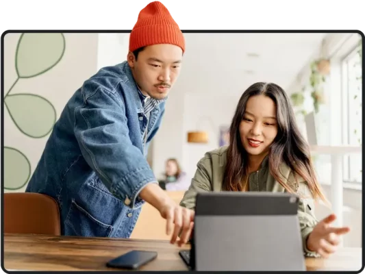 Two people looking at a tablet screen