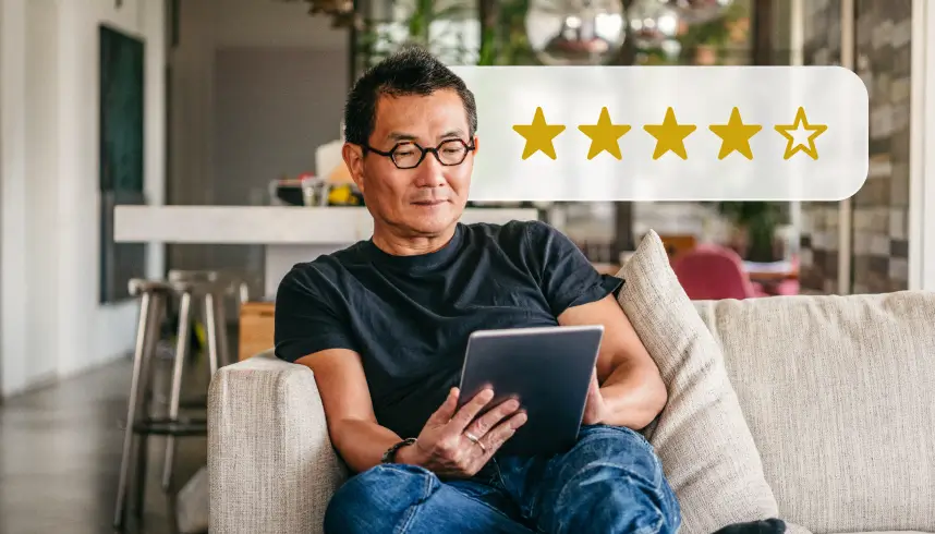 A photo of a man sitting on a couch, looking at a tablet. Above him is a five-star rating graphic with four full stars and one empty star.