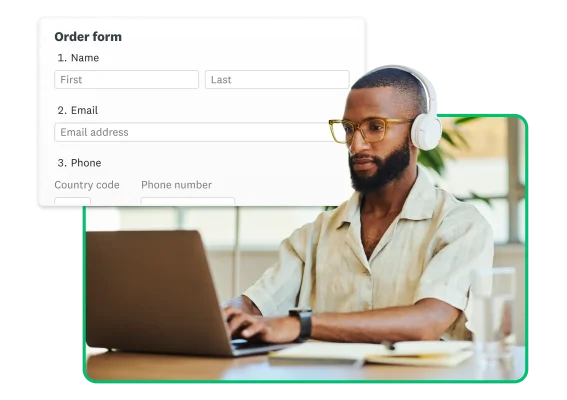 Man sitting at a desk using a laptop wearing headphones with product screenshots floating around him