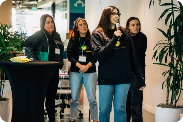 Valokuva WIN-työntekijäryhmän jäsenistä puhumassa lavalla